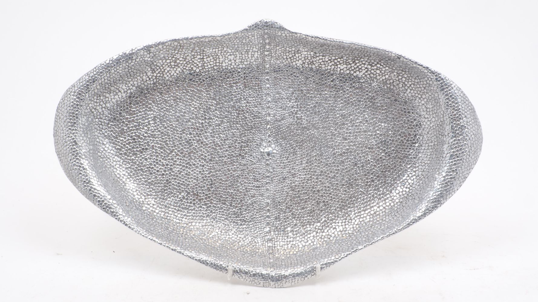 A white metal tray, 20th Century, designed in the shape of a stingray with scale effect