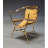 A gilt metal classical taste armchair, late 20th Century, with tan leather seat on curved backrest