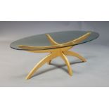 A Content by Conran coffee table, of recent manufacture, the oval glazed top on curved oak supports,