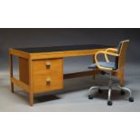 A modern birch veneered desk, late 20th Century, the rectangular top, inset with black laminate