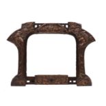 An Arts & Crafts repousse copper on wood mirror, early 20th century, the arched plate flanked by