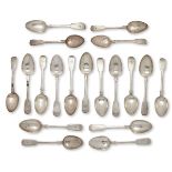 A selection of Georgian and Victorian silver dessert spoons, all of fiddle pattern design with