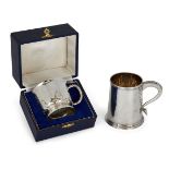 Two silver christening cups by Garrard & Co., the first designed as a small tankard with beaded