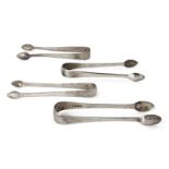 Four pairs of Georgian silver sugar tongs, of plain, tapering form, comprising three pairs of George