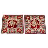 A pair of Kirman small mats, mid to late 20th century, with floral decoration in deep red field,