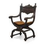 A Victorian style carved Savonarola chair, 20th century, the top rail with carved scrolling