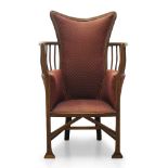 An Edwardian armchair in the manner of Liberty & Co, the shaped back with curved armrests having