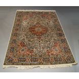 A Modern Kashan silk rug, with pole medallion in an ivory floral and foliate field, with brick red