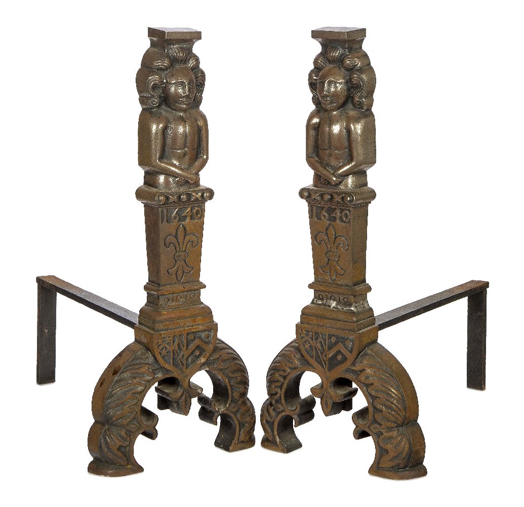 A pair of large cast iron fire dogs, 17th century style, the uprights each cast with a figural