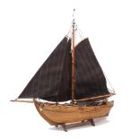 A scratch-built model of a boat, second half 20th century, with rigged twin sails, 77cm longPlease