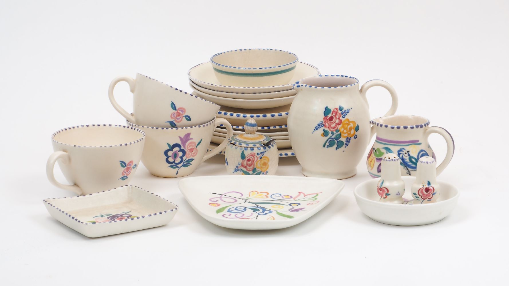 A Poole pottery part tea service, early to mid 20th century, decorated with various abstract flora