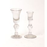 A George II cordial glass, c.1730, with baluster tear drop stem, 15.2cm high; together with a George