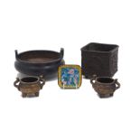 A Chinese low twin handled bronze censer, raised on tripod feet, gilt character mark to the