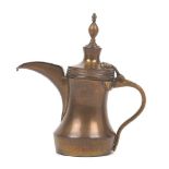 A Turkish / Islamic brass dallah coffee pot, 19th Century, the body and spout with hinged lids,