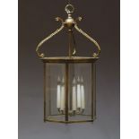 A brass and glazed six light hall lantern, 20th Century, of hexagonal form with scrolling