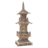 A Chinese bone two tier pagoda, early 20th century, carved with dragons, birds, and floral motifs,