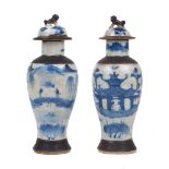 A pair of Chinese porcelain baluster vases and covers, late 19th/early 20th century, painted in