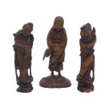 Three Chinese carved hardwood figures, early 20th Century, including a bare-chested monk and a pair,