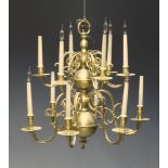 A large Dutch style twelve light brass ceiling light, second half 20th Century, with two tiers of