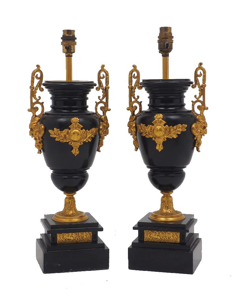 A pair of French slate gilt metal mounted urn-form table lamps, early 20th century, with mask and