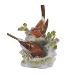 A Meissen bird group, 20th Century, depicting two robins tending a nest containing two small eggs