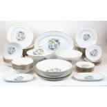 A modern Limoges dinner and dessert service, decorated with exotic birds and flowers, with gilt rims