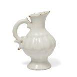WITHDRAWN; A Holics faience jug, mid 18th century, in a white glaze with moulded body and handle,