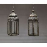 A pair of white metal and glazed hall lanterns, 20th Century, of hexagonal form with pierced domed