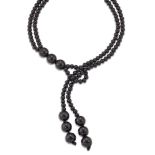A jet lariat necklace, composed of twin rows of jet beads to a loop and twin triple bead