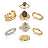 Eight various gold and gem rings, comprising: a claw-set oval sapphire ring of crossover design with