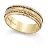 An 18ct two colour gold diamond band ring, the textured band with white gold ropework detail and set