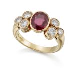 An 18ct gold ruby and diamond ring, the oval ruby collet between brilliant-cut diamond three stone