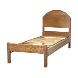 Heal's (British), a limed oak child’s bed frame, c.1920, with applied ivorine plaque to