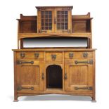 An Arts & Crafts oak sideboard, c.1905, The upper section with a projected cornice, two astragal