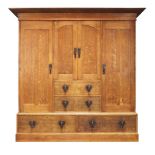 An Arts and Crafts oak triple wardrobe, possibly 'Glasgow School', c.1900, The moulded cornice