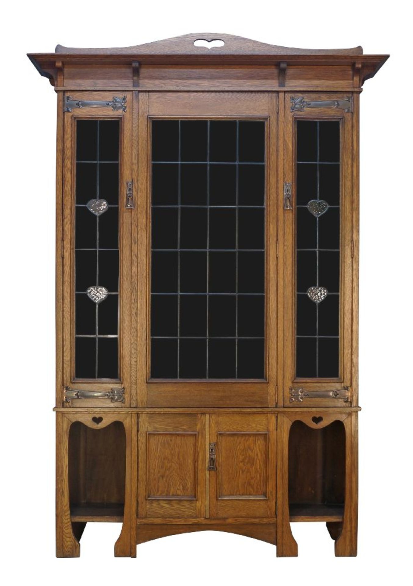 An Art Nouveau oak bookcase, c.1905, The moulded cornice surmounted by arched panel with pierced