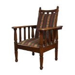 An Arts and Crafts oak reclining armchair, c.1910, The slatted backrest with spade shaped finials