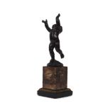 A Continental bronze model of a putti, 19th Century, modelled with arms raised aloft, atop a marbled