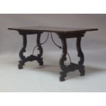 A 20th Century ebonised trestle table, knock down form, shaped supports, measuring 76cm high,