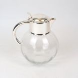 A large silver plate mounted glass water jug, the bulbous glass body to a rounded silver plated