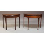 Two George III mahogany fold-over Demilune card tables, comprising one with rosewood cross-