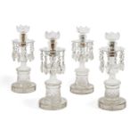 A set of four Regency clear cut-glass candlesticks, with crenulated sconces and teardrop lustres