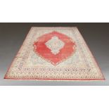 An Indian Agra pattern carpet, the whole medallion with a border of botehas in a red field, with