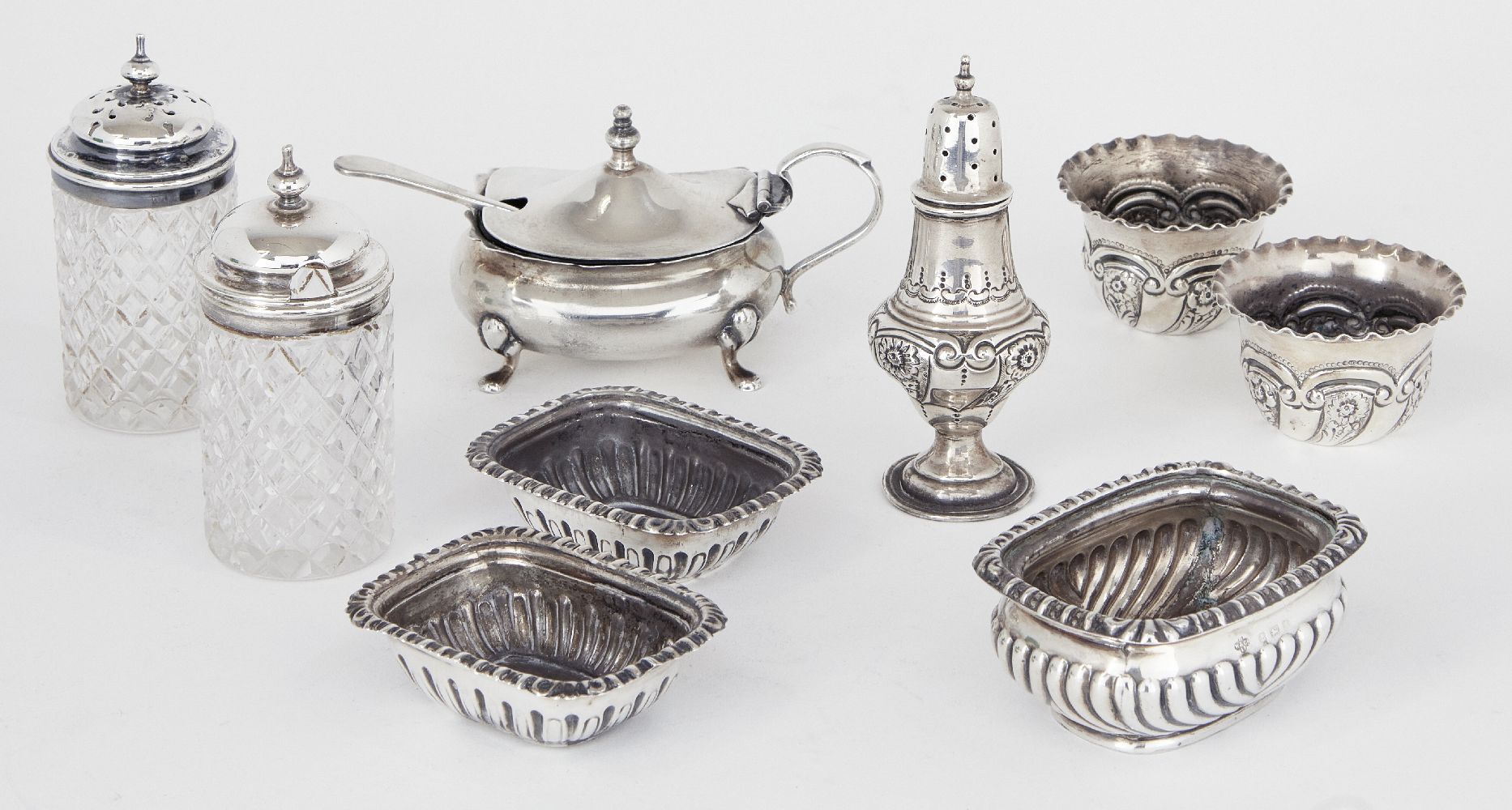 A three-piece silver cruet set, London, c.1901, Josiah Williams & Co, the two circular salts and