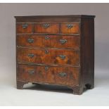 A George I walnut chest of drawers, circa 1720, fitted with three short drawers over three long