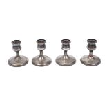 A set of four Japanese candlesticks, stamped pure silver, Yamato Bros, Kobe, of hammered design,