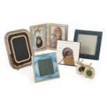A blue enamel and gilt metal photo frame, together with a further five variously designed photo