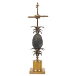 A brass table lamp, 20th Century, modelled with a pineapple and flourishing leaves atop a knopped