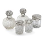 Five silver mounted glass vanity vessels, including: a pair of globular cut glass examples,