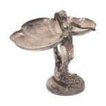 A figural tazza, 20th century, in the WMF style, depicting a woman standing atop a cornucopia,